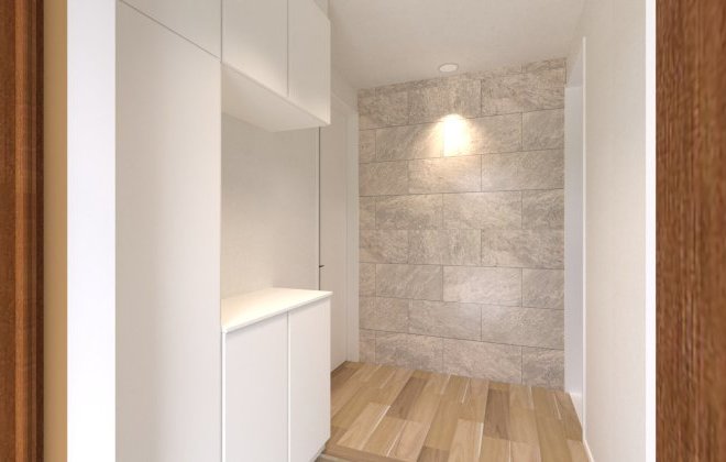 石目調のアクセントウォールが印象的な玄関ホール。照明に照らされた壁面が上質な雰囲気を演出し、来客を迎える空間としても魅力的です。※画像はイメージパースです